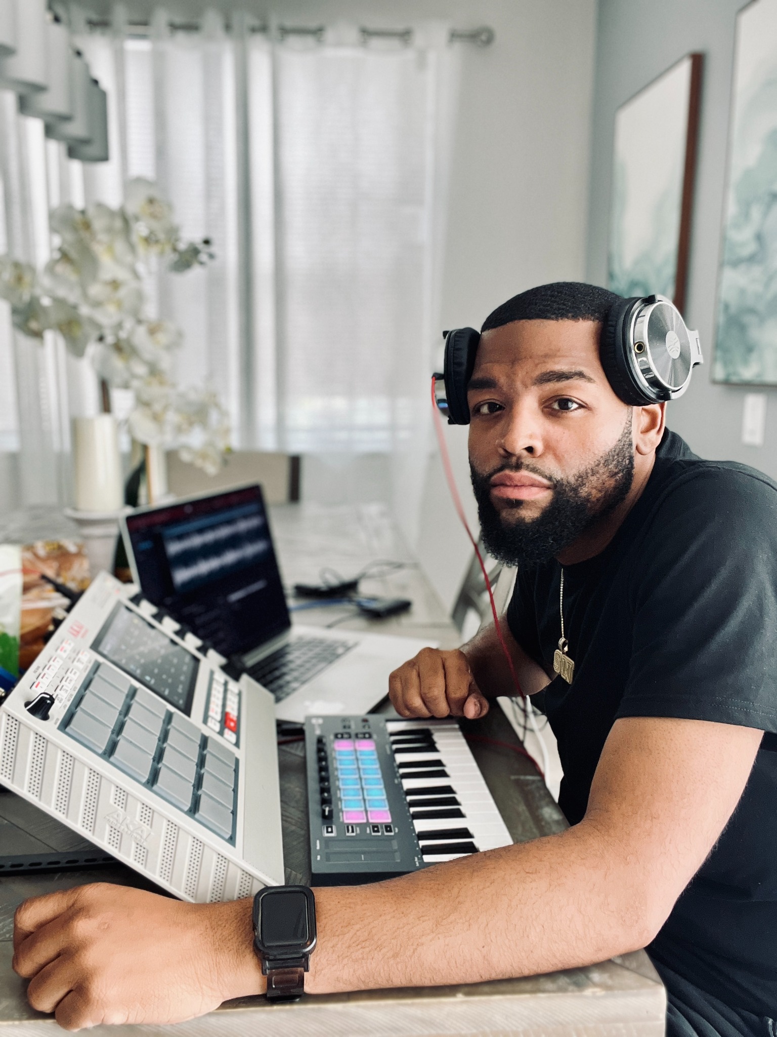 Justin Smooth Branch wearing headphones at his music production workstation